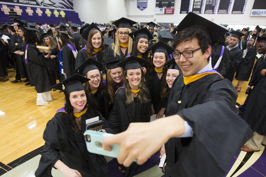 Students gather for a selfie at Commencement.